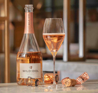 Wild Idol Non Alcoholic Rose Wine bottle and glass half poured